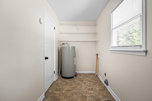 laundry room featuring electric water heater