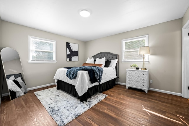 bedroom featuring dark hardwood / wood-style floors and multiple windows