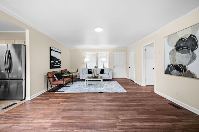 living room with crown molding and wood-type flooring