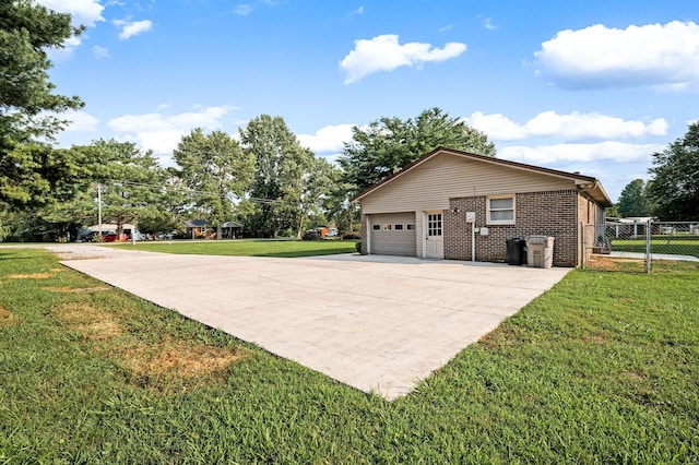 view of side of property featuring a garage and a lawn