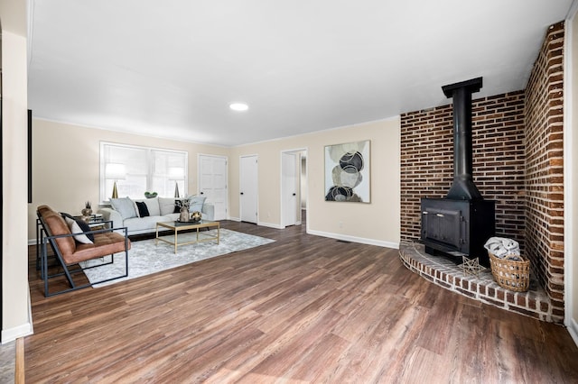 living room featuring hardwood / wood-style floors and a wood stove