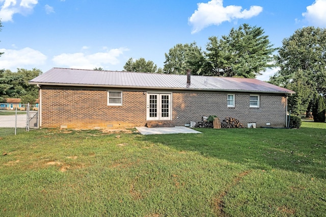 rear view of house featuring a yard, a patio area, and french doors