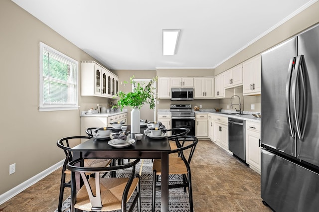 kitchen with white cabinetry, stainless steel appliances, and sink