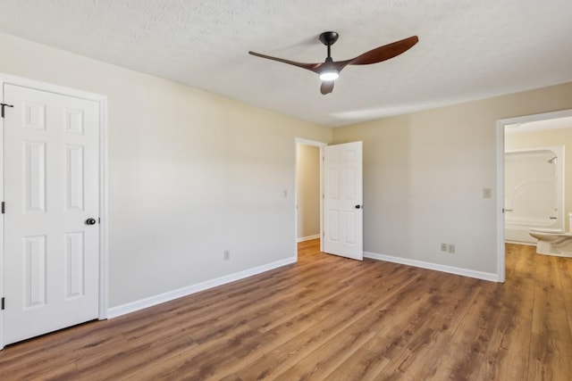 empty room with hardwood / wood-style flooring, a textured ceiling, and ceiling fan