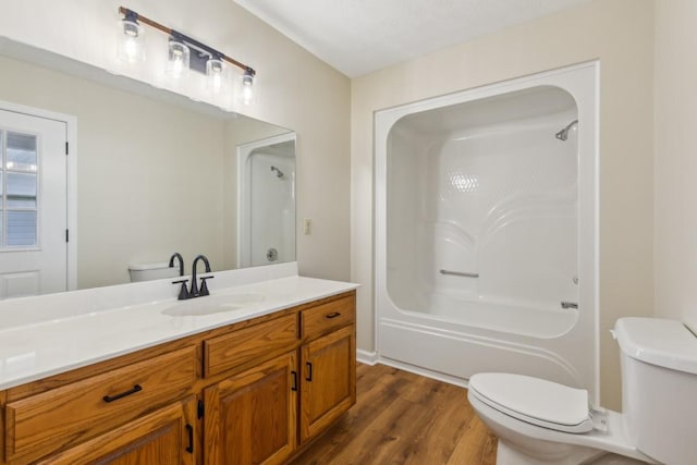 bathroom featuring vanity, hardwood / wood-style floors, and toilet