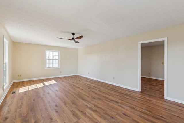 spare room with hardwood / wood-style floors and ceiling fan