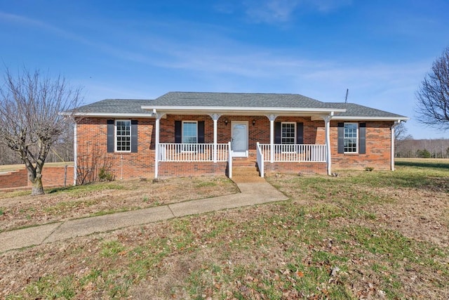 ranch-style home with a porch and a front lawn