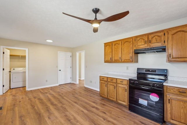 kitchen featuring ceiling fan, washer / clothes dryer, light hardwood / wood-style floors, and electric range