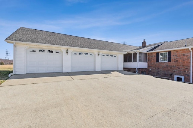 view of front facade featuring a garage and a sunroom