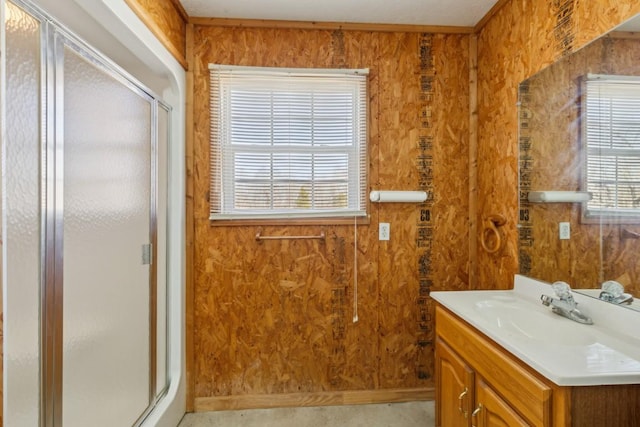 bathroom featuring vanity, wooden walls, and an enclosed shower