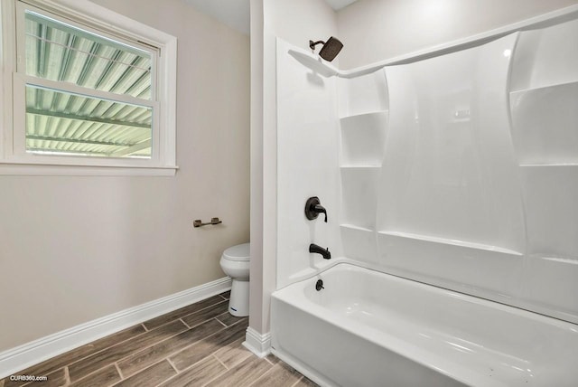 bathroom featuring bathtub / shower combination and toilet