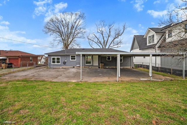 rear view of house with a patio and a yard