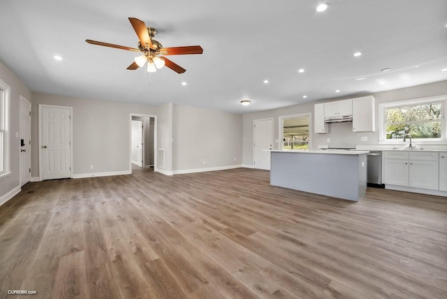 kitchen featuring dishwasher, white cabinets, ceiling fan, and light hardwood / wood-style flooring