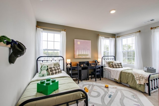 bedroom featuring light carpet