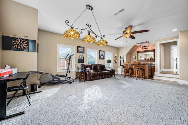 interior space featuring ceiling fan, bar, and carpet flooring