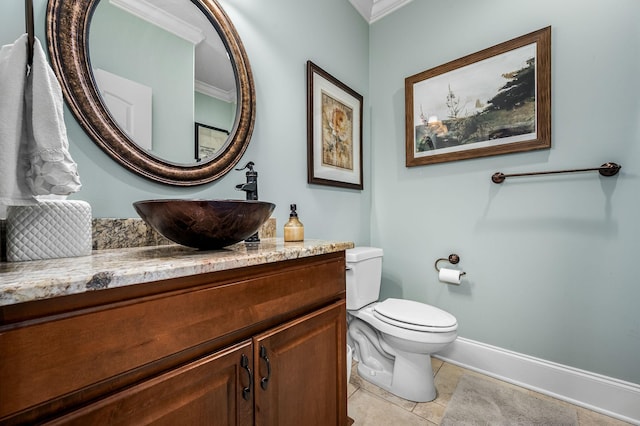 bathroom with tile patterned flooring, vanity, ornamental molding, and toilet