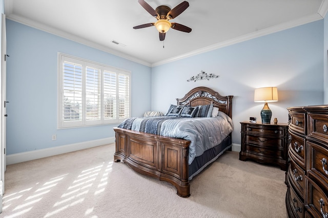 carpeted bedroom with ceiling fan and ornamental molding