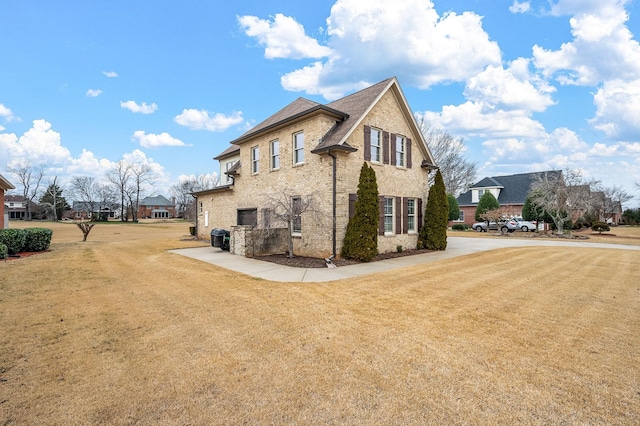 view of side of home featuring a yard