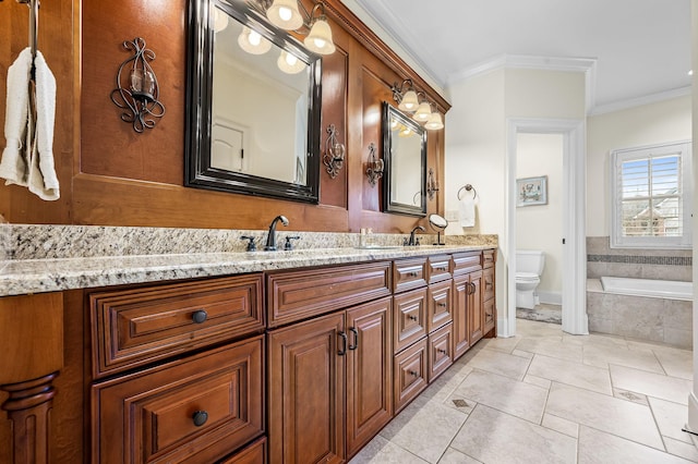 bathroom with tile patterned floors, toilet, crown molding, vanity, and a relaxing tiled tub