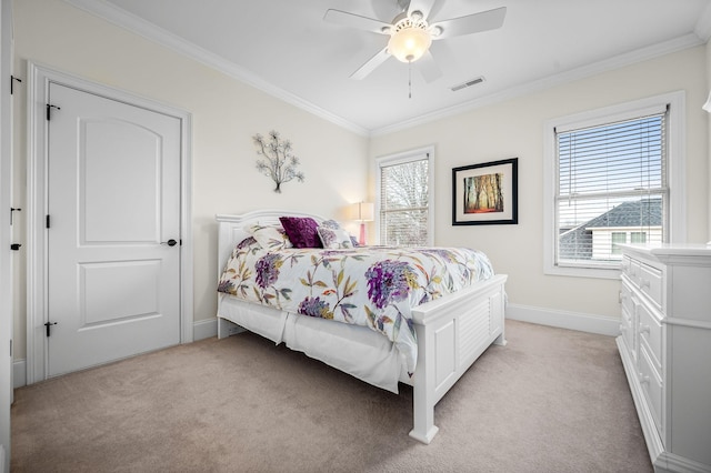 bedroom featuring crown molding, light colored carpet, and ceiling fan