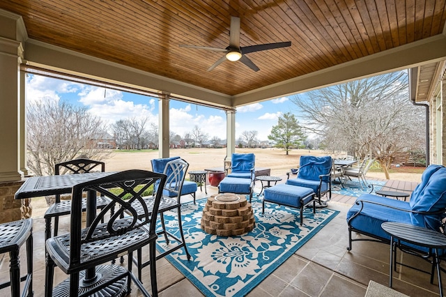 view of patio with an outdoor living space with a fire pit and ceiling fan