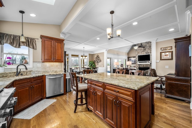 kitchen featuring stainless steel appliances, hanging light fixtures, and a center island