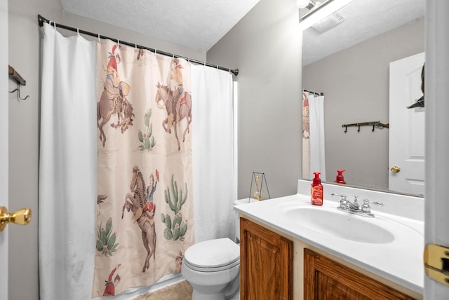 bathroom featuring walk in shower, vanity, toilet, and a textured ceiling