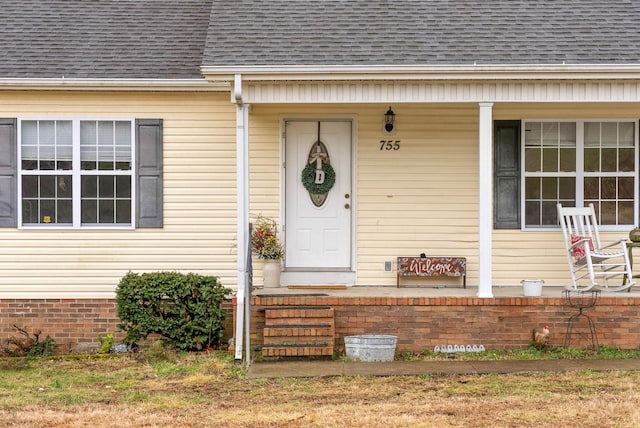 view of exterior entry with covered porch