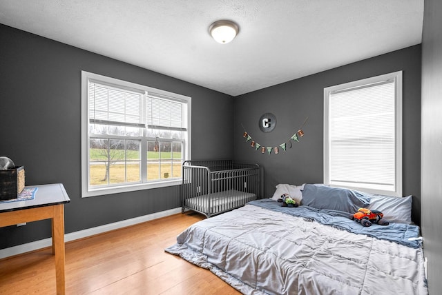 bedroom with wood-type flooring and a textured ceiling