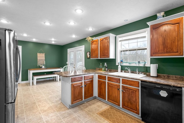 kitchen with dishwasher, sink, stainless steel refrigerator, and kitchen peninsula