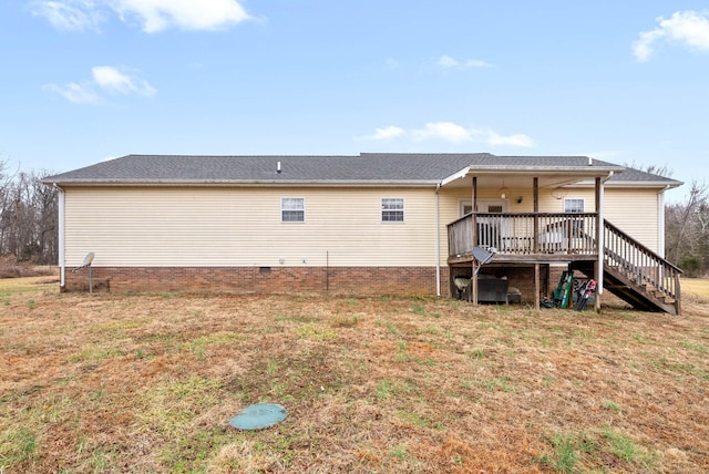 back of house featuring a yard and a deck