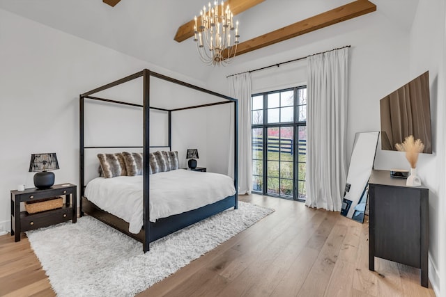 bedroom with beamed ceiling, light hardwood / wood-style floors, and a notable chandelier