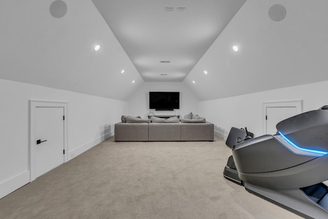 cinema with vaulted ceiling and light colored carpet