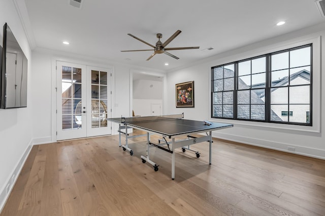 game room with light hardwood / wood-style flooring, ornamental molding, french doors, and ceiling fan