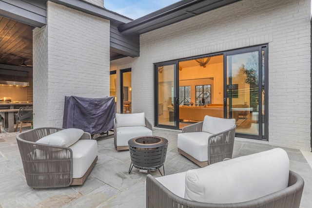 view of patio / terrace featuring an outdoor living space with a fire pit