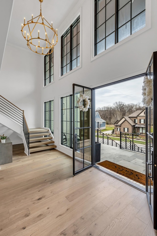 entryway featuring a notable chandelier and wood-type flooring