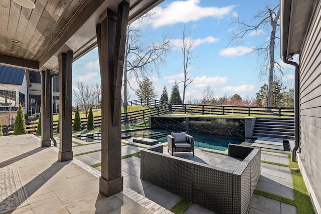 view of patio / terrace with a swimming pool with hot tub