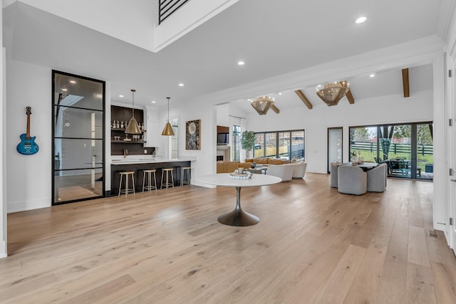 living room featuring beam ceiling and light wood-type flooring