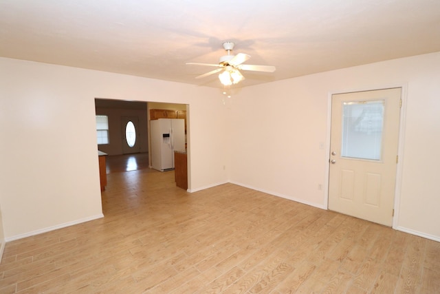 spare room featuring ceiling fan and light hardwood / wood-style floors