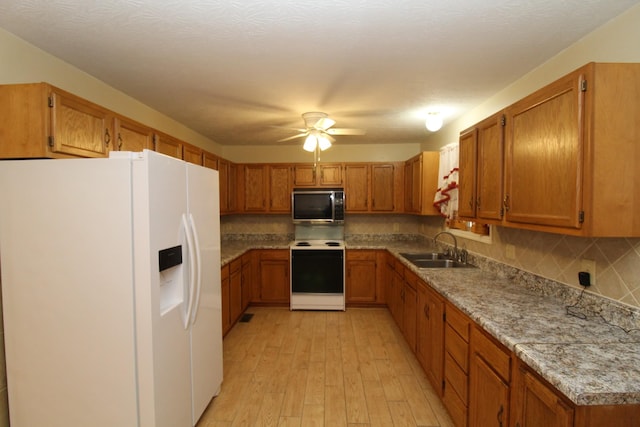 kitchen featuring sink, white appliances, ceiling fan, tasteful backsplash, and light wood-type flooring