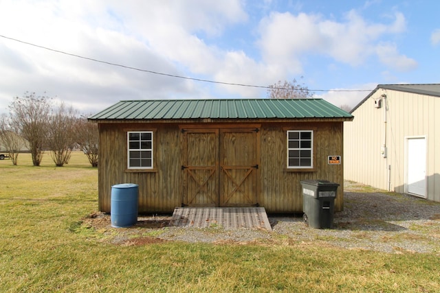 view of outdoor structure featuring a lawn