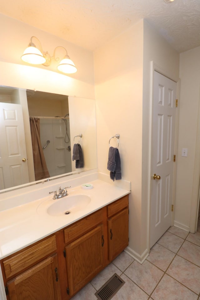 bathroom with tile patterned flooring, vanity, and a shower with shower curtain