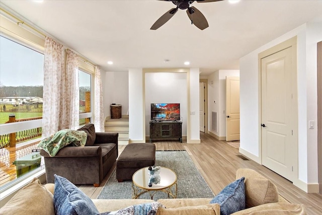 living area with light wood-type flooring, visible vents, baseboards, and recessed lighting