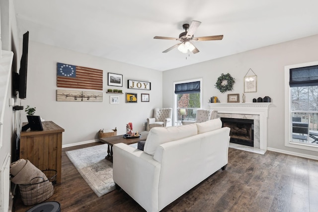 living room featuring dark hardwood / wood-style floors, a fireplace, and ceiling fan