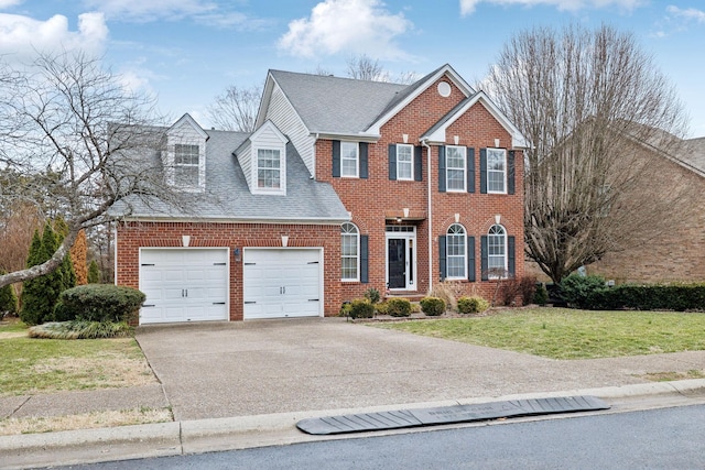 view of front of house with a garage and a front yard