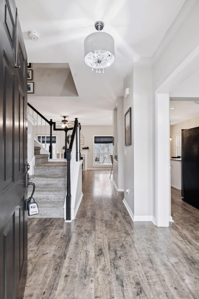 foyer with hardwood / wood-style flooring and a chandelier