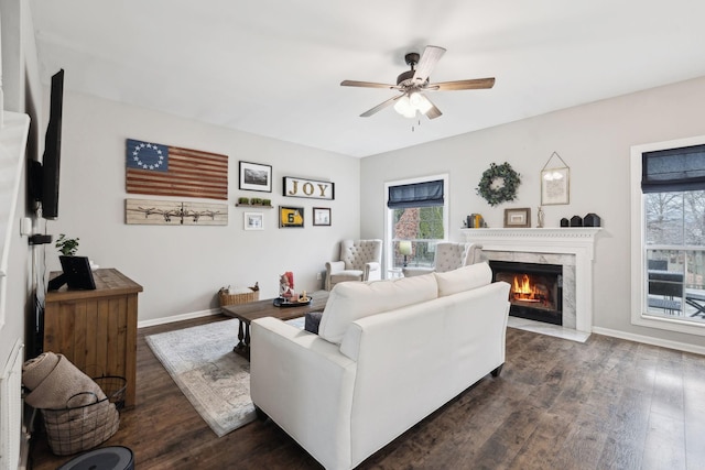 living room with dark hardwood / wood-style flooring, a fireplace, and ceiling fan