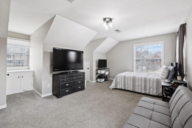 bedroom with vaulted ceiling and light colored carpet