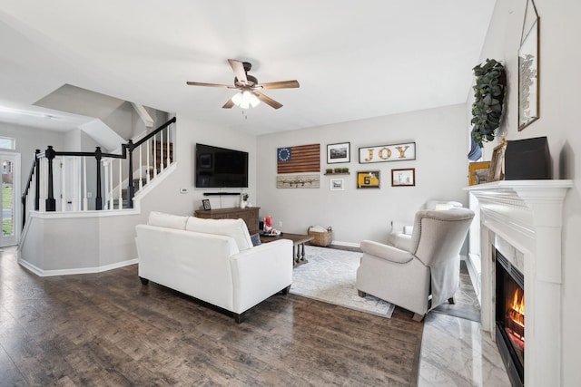 living room featuring ceiling fan and dark hardwood / wood-style floors