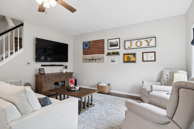 living room featuring hardwood / wood-style flooring and ceiling fan